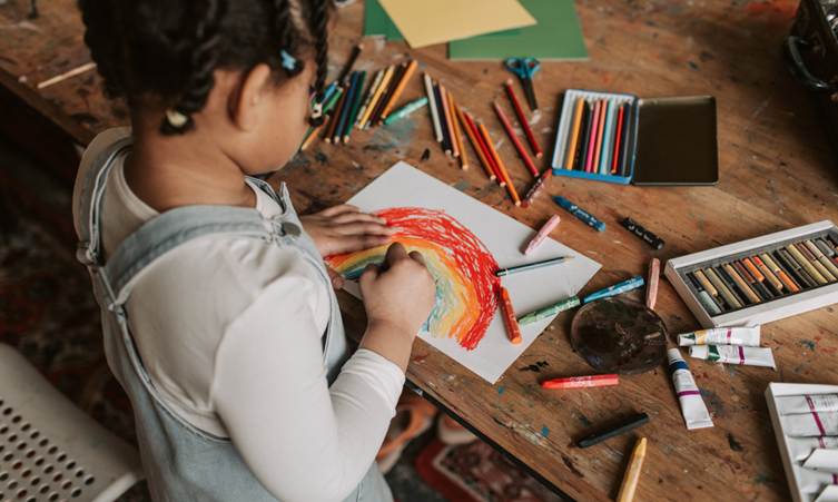 Fine Motor Skills Printable Activities for Preschool & Kindergarten: kids colouring a sheet with crayons.